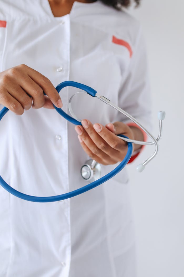 A healthcare professional holding a blue stethoscope, highlighting medical care.